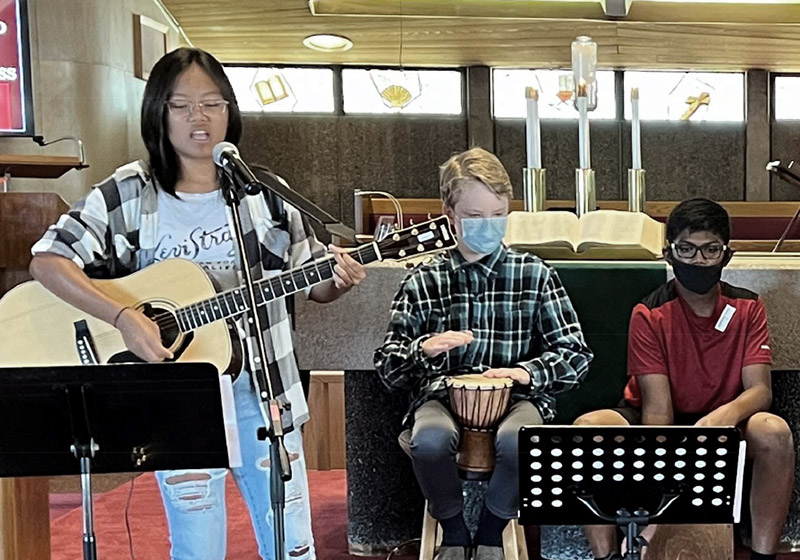 teens singing and playing instruments in the church sanctuary