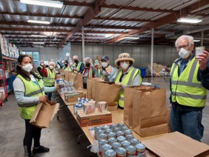 volunteers packing food donations in boxes