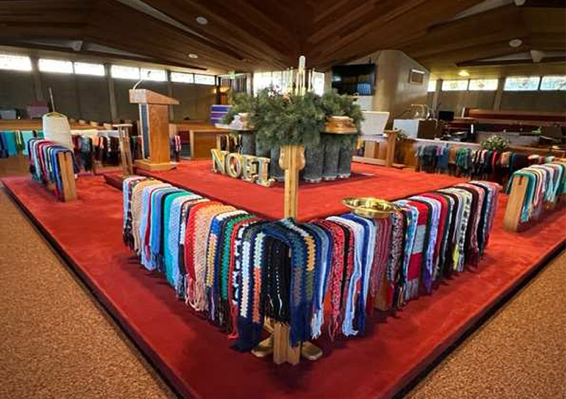 many handcrafted scarves arranged around the sanctuary