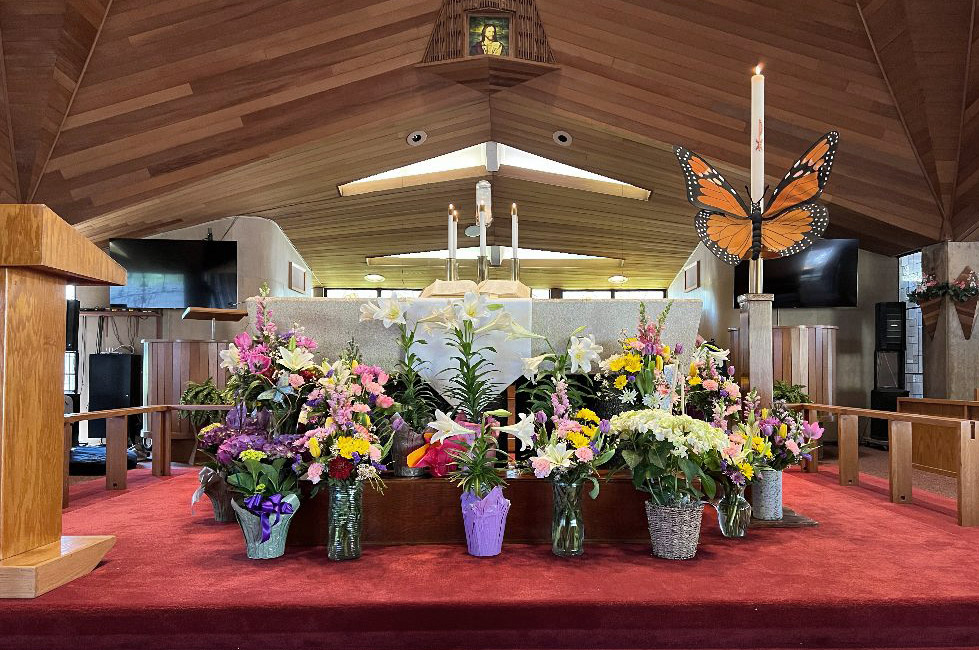 lilies and spring flowers decorate the altar in the sanctuary